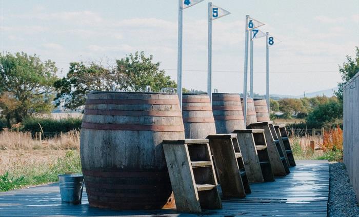 A view of the bathing barrels and steps at Halen Môn's Wild Môn Seaweed Baths